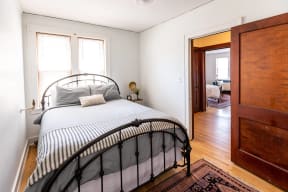 a bedroom with a bed and a door to a bathroom