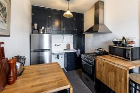 a kitchen with a wooden table and a stove and refrigerator