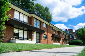 a row of brick apartment buildings on a sidewalk