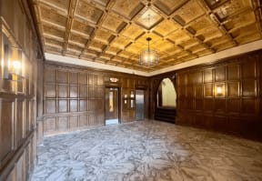 a large room with wood paneled walls and a coffered ceiling