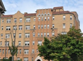 a large brick building with trees in front of it