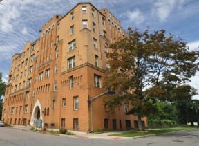 a large brick building on the corner of a street