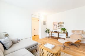 a living room with a couch and a chair and a table