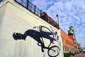 a mural of a horse and carriage on the side of a building