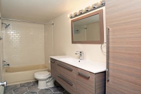 a bathroom with a toilet sink and a mirror