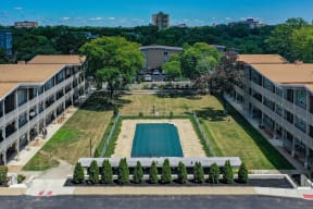an aerial view of a pool in the middle of a building