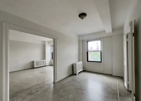 an empty room in a building with a window