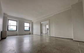 a large empty room with white walls and windows
