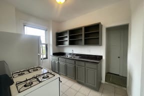 a kitchen with a stove and a sink and a refrigerator