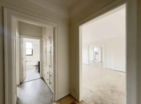 a empty room with a door to a hallway and a closet
