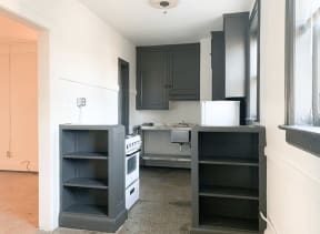 a kitchen with black cabinets and a stove