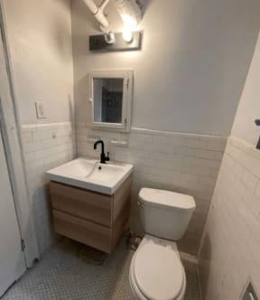 a bathroom with a toilet and a sink