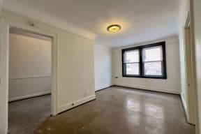 the living room of an empty house with a window