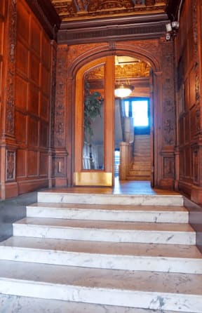 the entrance to an old building with stairs and a door