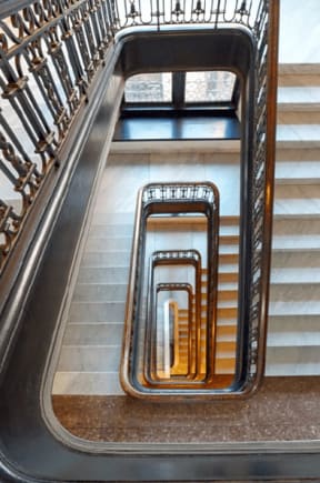 an aerial view of an escalator and stairs in a building