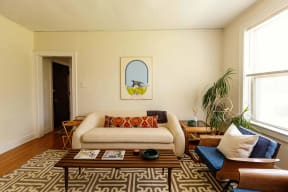 a living room with a couch and a rug