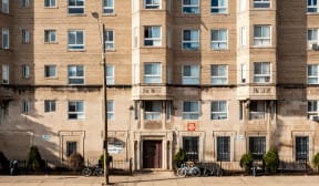 a brick building with bikes parked in front of it