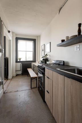 a kitchen with wooden cabinets and a sink and a window