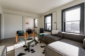 a living room with a couch and a glass coffee table