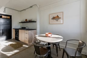 a small kitchen and dining room with a table and chairs