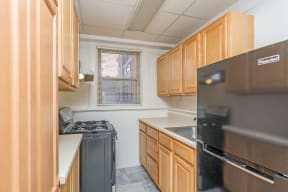 a kitchen with wooden cabinets and a stove and refrigerator
