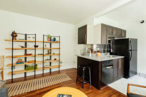 a kitchen with a black refrigerator and a counter top