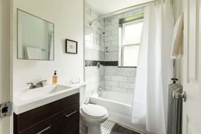 a bathroom with a sink toilet and a shower