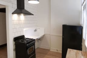 an empty kitchen with a stove and a refrigerator