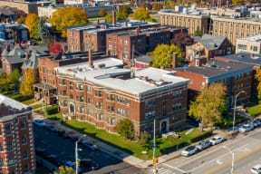 an aerial view of a brick building with a white roof