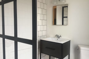 a small bathroom with a sink and a mirror