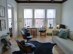 a living room with a couch and chairs and a table