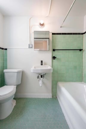 a bathroom with a toilet sink and a tub