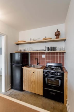 a small kitchen with a stove refrigerator and sink