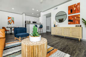 a living room with a couch and a table with a cactus