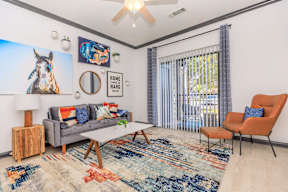 a living room with a couch and a table and a window
