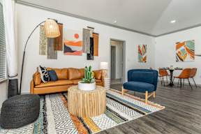 a living room with a couch and a chair and a table