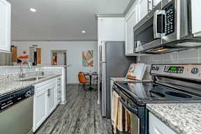 a kitchen with stainless steel appliances and white cabinets