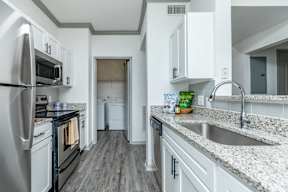 a kitchen with granite counter tops and stainless steel appliances