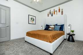 a bedroom with a white bed and a brown blanket