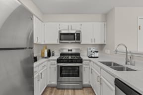 a kitchen with stainless steel appliances and white cabinets