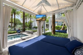 a bedroom with a bed and a view of a pool and palm trees