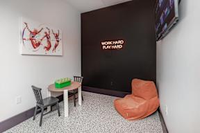 community room with small table, television, and lounge chair