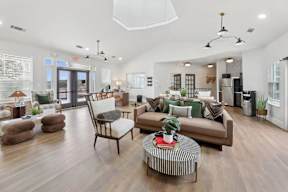 A living room with a brown sofa, a coffee table, and a dining table.