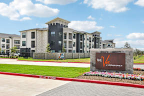 The Jordan Ranch apartments are located in a sunny, green area.
