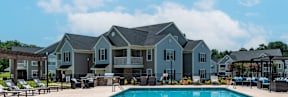 A large house with a pool in front.