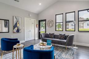 A living room with a blue sofa and a coffee table.