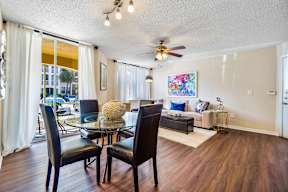 A living room with a glass table and chairs.