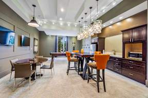 A modern dining room with a large table and chairs.