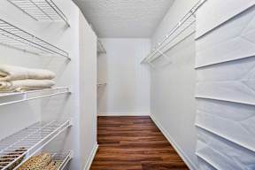 A white refrigerator with a white towel on the top shelf.