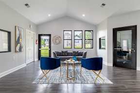 A living room with a blue chair and a coffee table.
